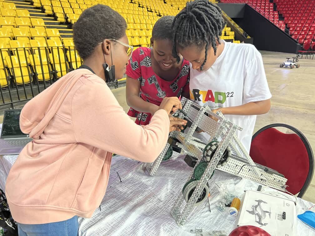 Students building a robot at a robotics workshop